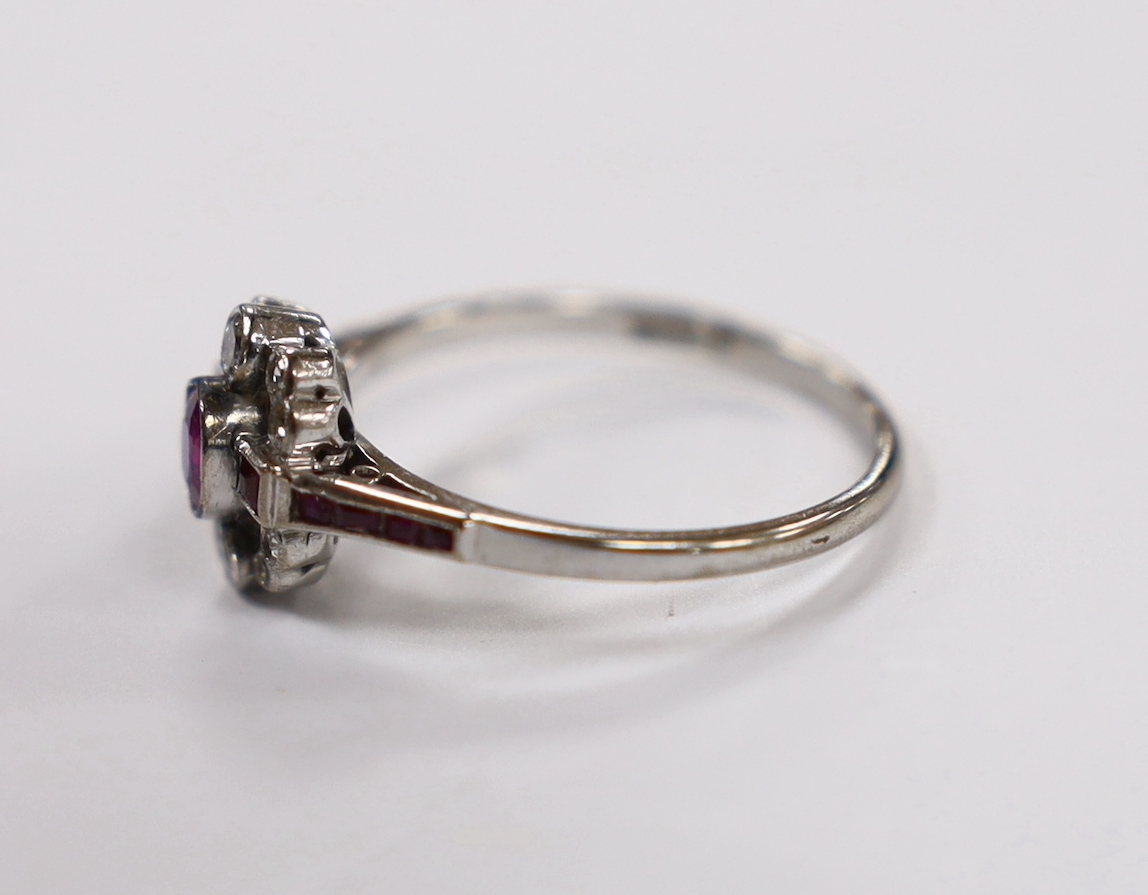 An Art Deco style 18ct white gold, ruby and diamond set cluster ring, size Q, gross weight 3.1 grams.